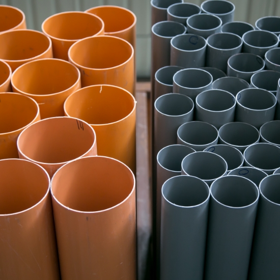 Shelves stocked with industrial plumbing pipes